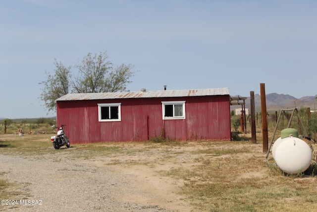 view of outdoor structure with a rural view and a mountain view