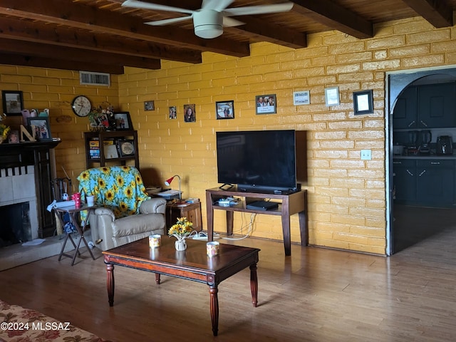 living room with wood ceiling, wood-type flooring, beam ceiling, and ceiling fan