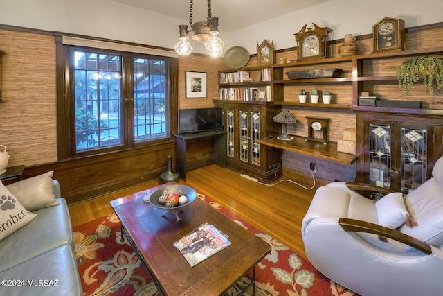 living room with dark wood-type flooring and a notable chandelier