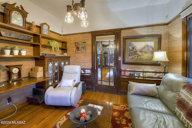 living room with hardwood / wood-style floors and a notable chandelier