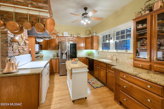 kitchen with light hardwood / wood-style flooring, wood counters, appliances with stainless steel finishes, decorative backsplash, and ceiling fan