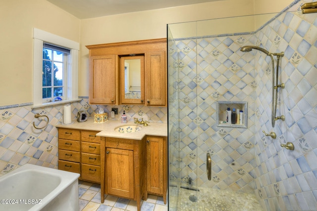 bathroom featuring tile patterned flooring, tile walls, independent shower and bath, tasteful backsplash, and vanity