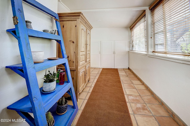 corridor with plenty of natural light and light tile patterned floors