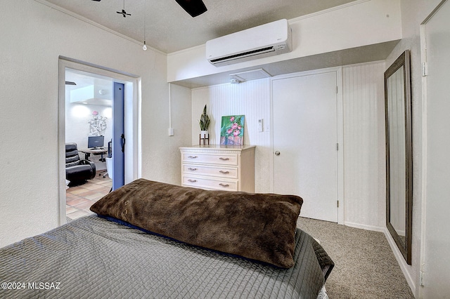 carpeted bedroom featuring a wall mounted AC, ornamental molding, ceiling fan, and a textured ceiling