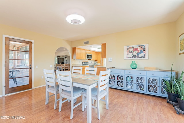 dining space featuring light wood-type flooring