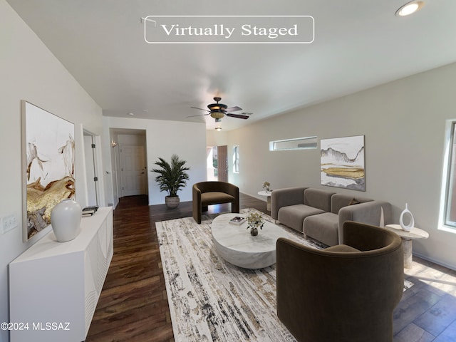 living room featuring ceiling fan and dark hardwood / wood-style floors