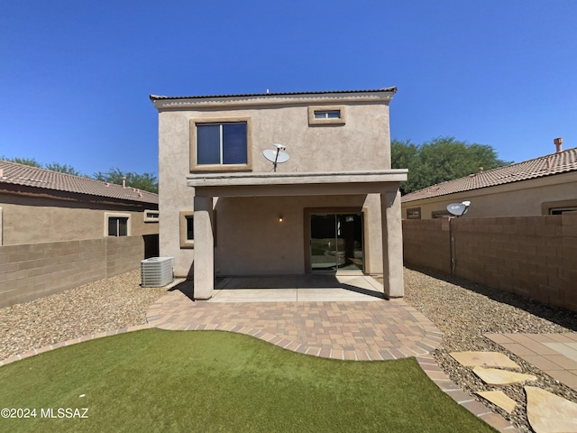 back of property with a patio area, central air condition unit, a fenced backyard, and stucco siding