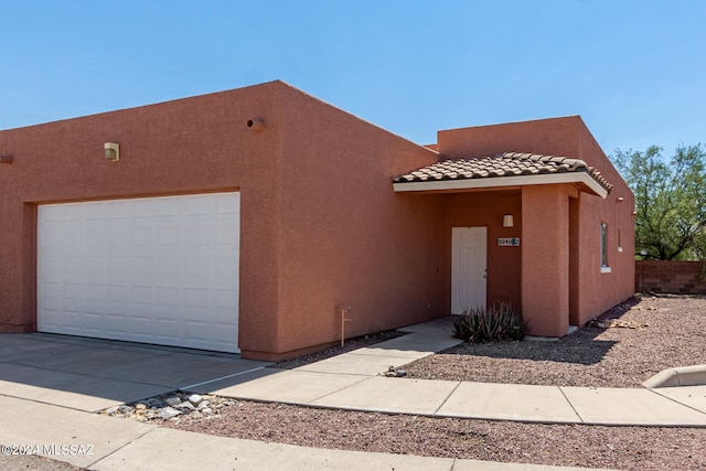 pueblo-style house with a garage