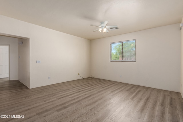 empty room featuring hardwood / wood-style floors and ceiling fan