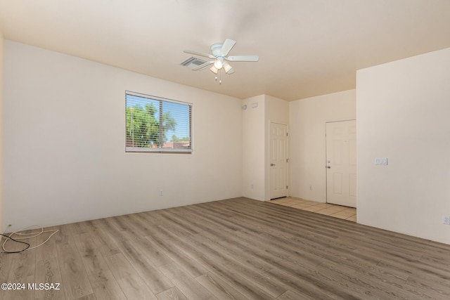 unfurnished room with ceiling fan and light hardwood / wood-style floors