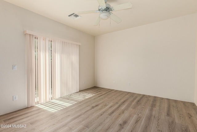 unfurnished room featuring light wood-type flooring and ceiling fan