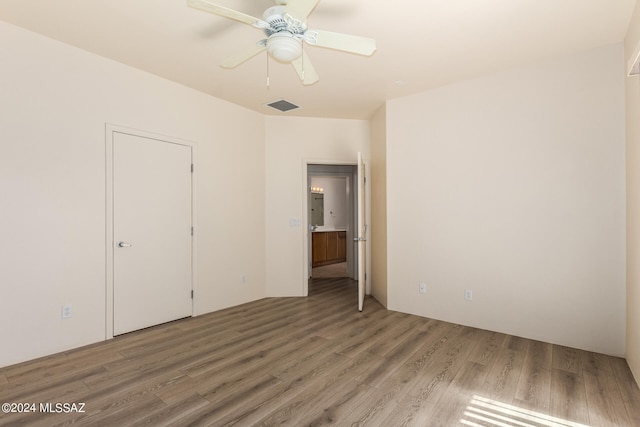 spare room with ceiling fan and hardwood / wood-style flooring