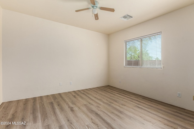 empty room with light wood-type flooring and ceiling fan