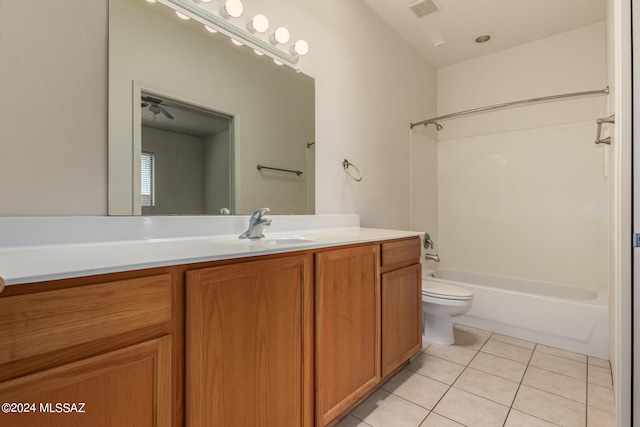 full bathroom featuring tile patterned floors, vanity, toilet, and  shower combination