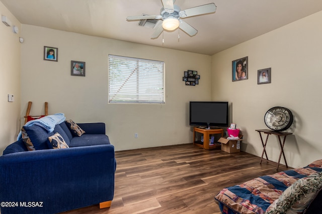 living room with ceiling fan and dark hardwood / wood-style flooring