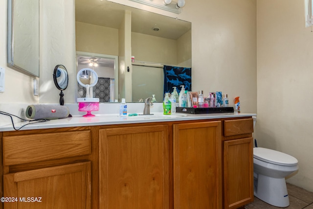 bathroom with toilet, tile patterned flooring, vanity, a shower, and ceiling fan