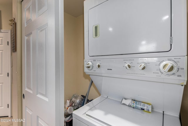 laundry room with stacked washer / dryer