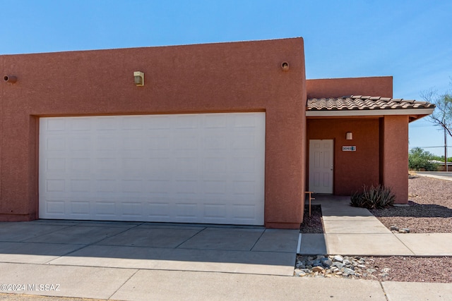 pueblo-style house with a garage