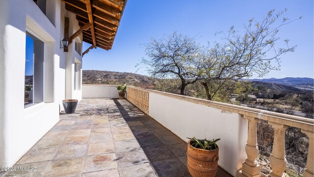 balcony with a mountain view and a patio