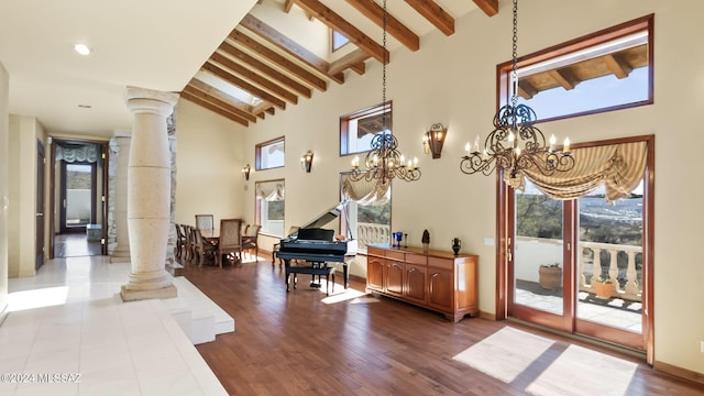 interior space featuring high vaulted ceiling, a wealth of natural light, and ornate columns