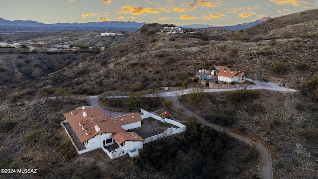 aerial view at dusk featuring a mountain view