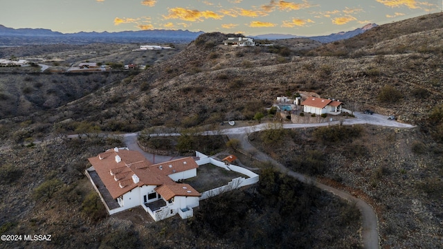 drone / aerial view with view of desert and a mountain view