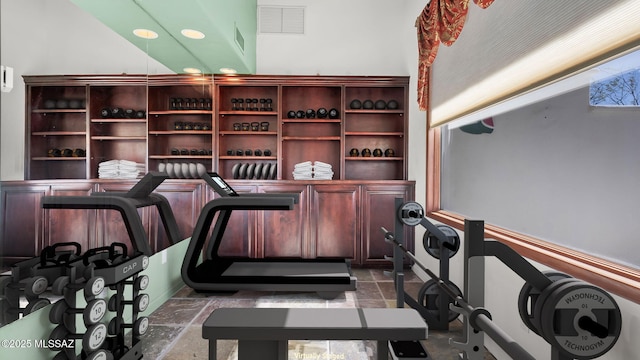 wine area with visible vents, recessed lighting, and stone finish flooring