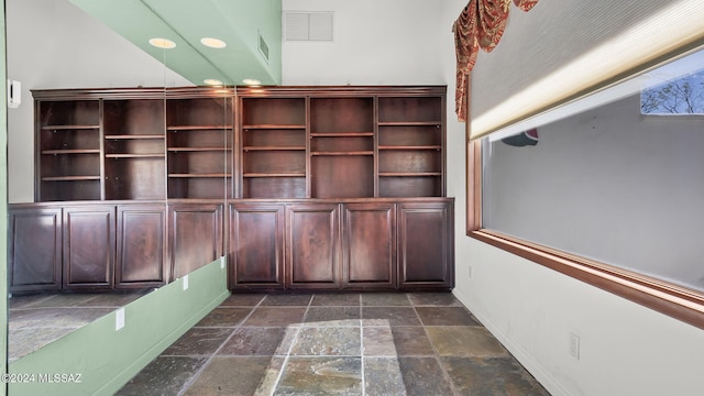 unfurnished office featuring baseboards, stone tile flooring, visible vents, and recessed lighting