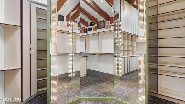 spacious closet featuring stone finish floor