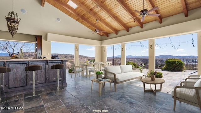 view of patio / terrace featuring a mountain view, outdoor lounge area, ceiling fan, and fence
