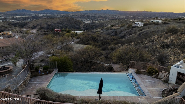 view of swimming pool featuring a fenced in pool, fence, and a mountain view