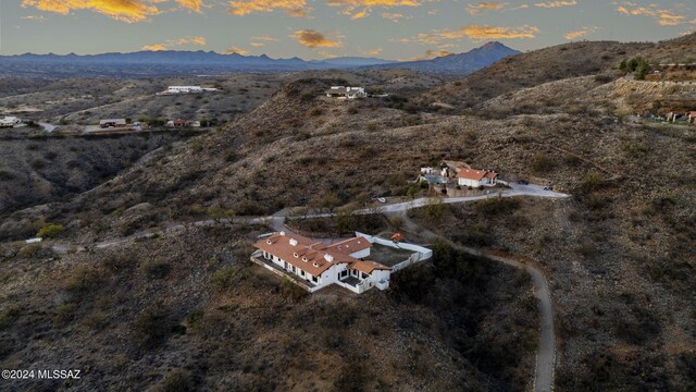 aerial view at dusk featuring a mountain view