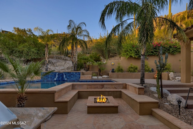 view of swimming pool with a patio area and an outdoor fire pit