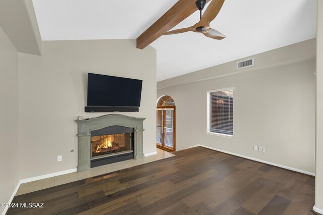 unfurnished living room with ceiling fan, vaulted ceiling with beams, and hardwood / wood-style flooring