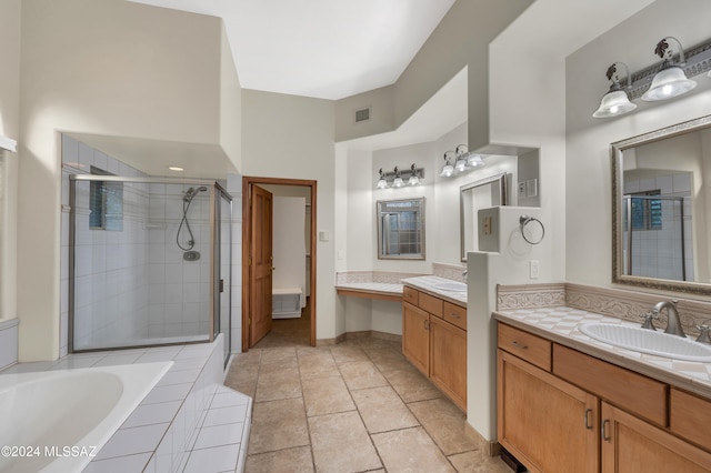 bathroom with shower with separate bathtub, tile patterned flooring, and vanity