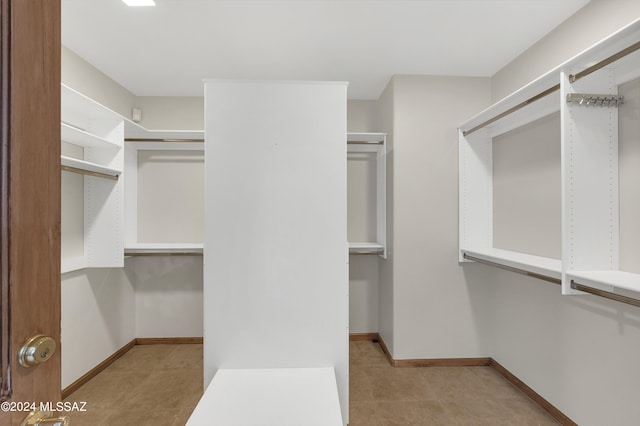 spacious closet with light tile patterned flooring