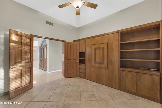 unfurnished bedroom with ceiling fan and light tile patterned floors