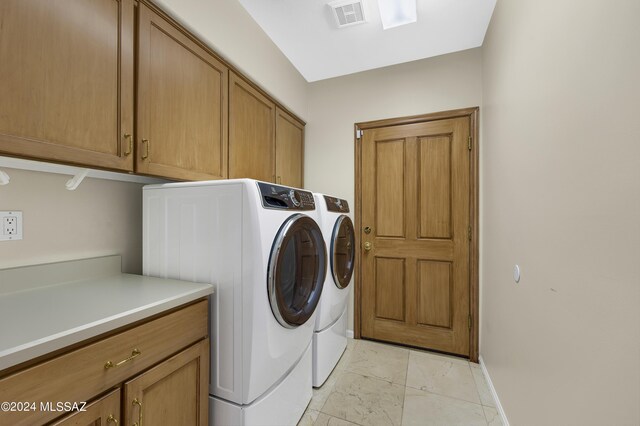 laundry area with cabinets and washer and dryer