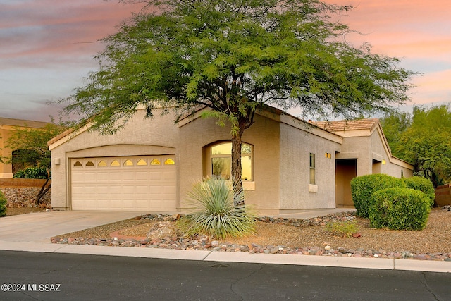 mediterranean / spanish-style house with a garage