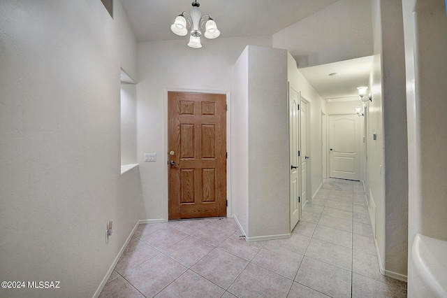 foyer entrance featuring an inviting chandelier and light tile patterned floors