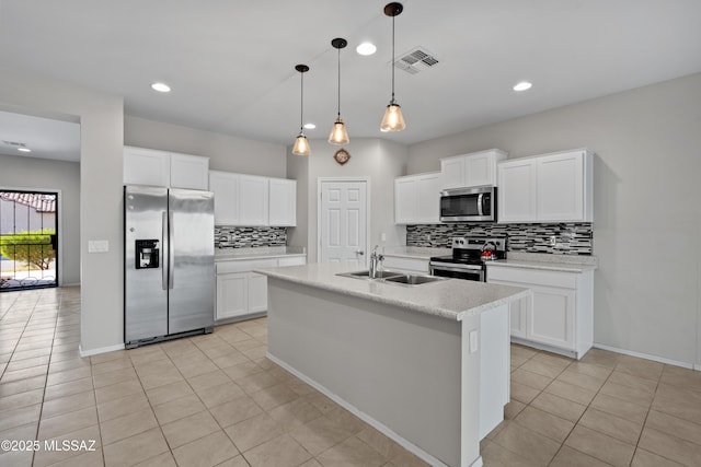 kitchen featuring appliances with stainless steel finishes, an island with sink, white cabinetry, and sink