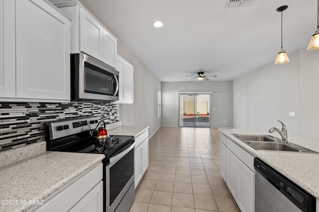 kitchen featuring sink, stainless steel appliances, white cabinetry, and light tile patterned flooring