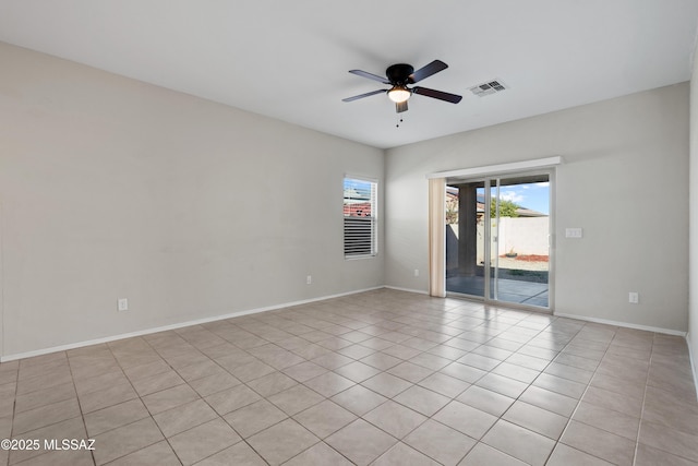 spare room featuring ceiling fan and light tile patterned flooring