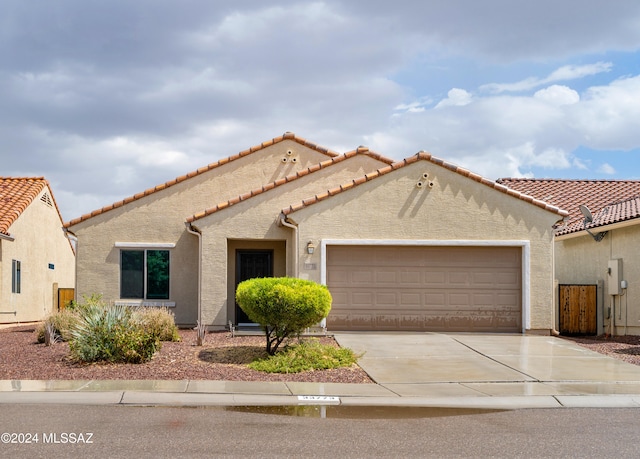 mediterranean / spanish-style home with a garage