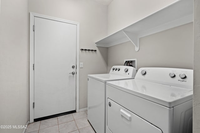 washroom featuring independent washer and dryer and light tile patterned floors