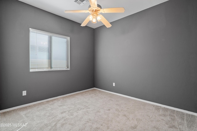 carpeted spare room with ceiling fan