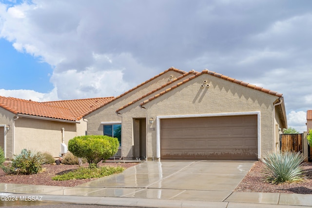 mediterranean / spanish-style home with a garage