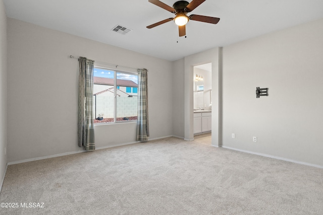 empty room featuring light colored carpet and ceiling fan