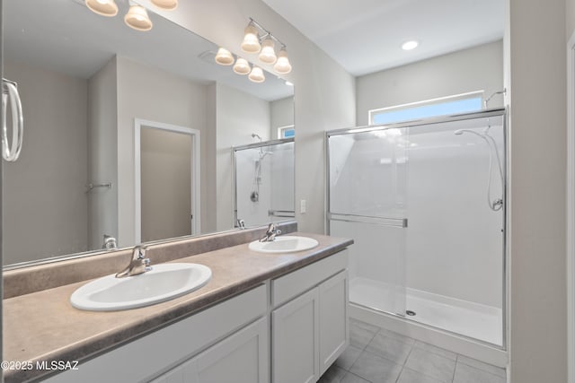 bathroom with vanity, walk in shower, and tile patterned flooring