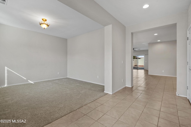 carpeted spare room featuring ceiling fan